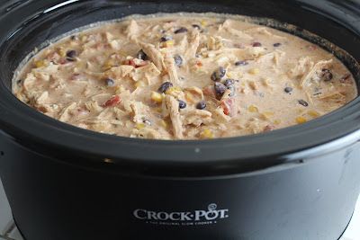 a crock pot filled with chicken and beans