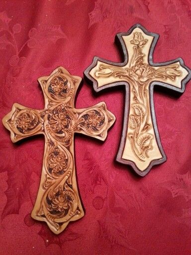 two wooden crosses sitting on top of a red cloth