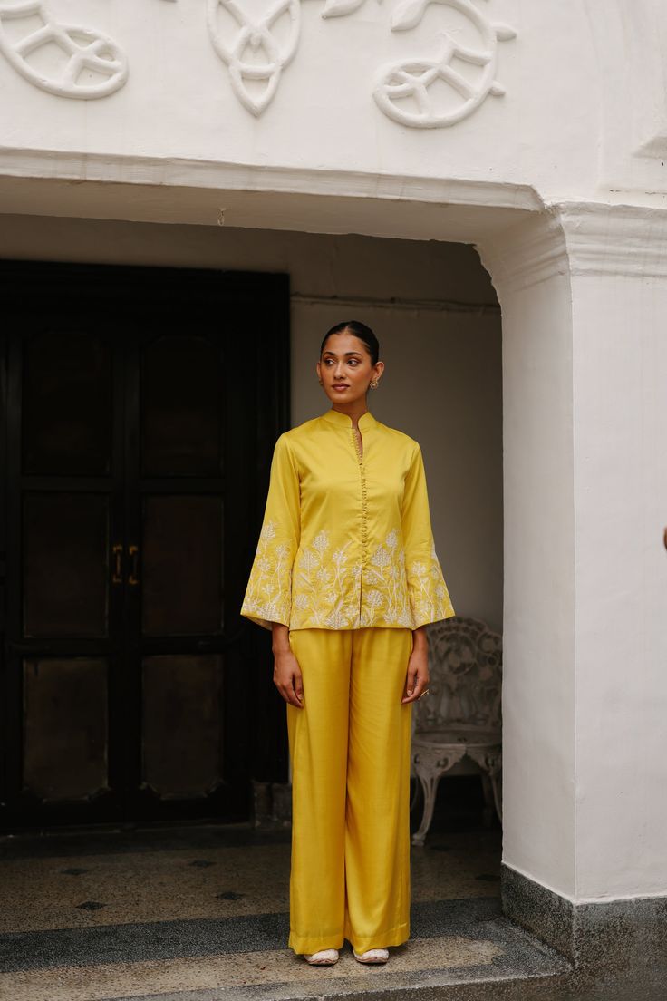 PRODUCT DETAIL: Discover a truly unique blend of structured elegance and fashionable comfort with our Yellow Embroidered Coat with Wide Pants. This ensemble redefines traditional and modern fashion, making it the perfect choice for upcoming festivities and formal occasions. The top, adorned with intricate embroidery, a Elegant Wedding Pants For Festive Season, Elegant Festive Wedding Pants, Traditional Set With Chikankari Embroidery And Wide Leg, Traditional Festive Pant Set With Set-in Sleeves, Elegant Fitted Pants For Festive Occasions, Elegant Sets With Set-in Sleeves And Straight Pants, Elegant Spring Palazzo Matching Set, Elegant Spring Matching Palazzo Set, Elegant Long Sleeve Pant Set For Festive Occasions