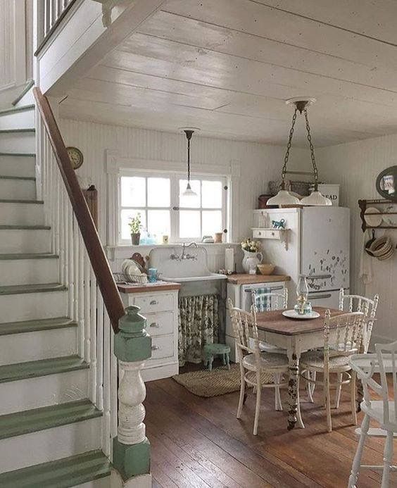 a kitchen and dining area with stairs leading up to the second floor in an old - fashioned home