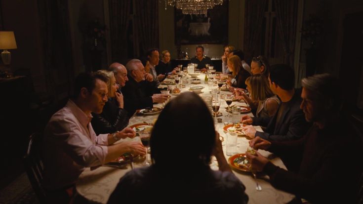 a group of people sitting around a dinner table