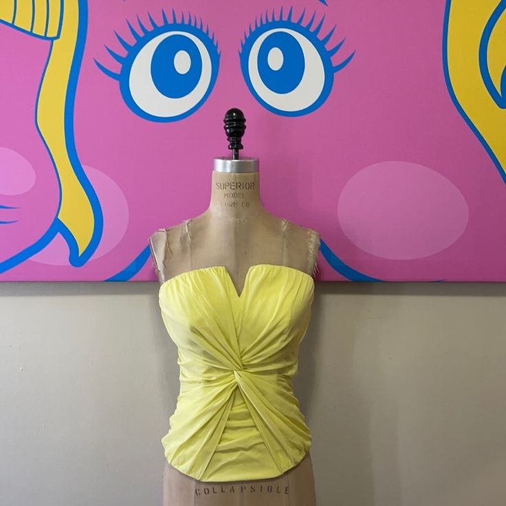 Summer Dressing Shines Wearing This Pale Yellow Silk Bustier By Bebe. Wear Along Or Under A Blazer With Pencil Pants Or Pencil Skirt. Size S Across Chest - 17 1/2 In. Across Waist - 13 In. Back To Bottom - 10 1/2 In. Material: 100% Silk Made In China Note: The Area At Zipper Top Closing Has Come Unstitched And Needs Repair. Fitted Flirty Tube Top With Built-in Bra, Fitted Bandeau Tube Top For Day Out, Fitted Yellow Ruched Top, Fitted Sleeveless Tube Top For Spring, Stretch Tube Top For Spring Party, Yellow Sleeveless Tube Top For Party, Yellow Fitted Sleeveless Tube Top, Fitted Yellow Sleeveless Tube Top, Fitted Strapless Party Tops