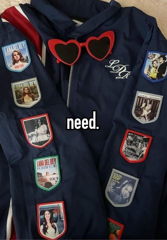 a blue jacket with patches and heart shaped sunglasses