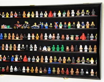 a display case filled with lots of small toy figurines on black shelving