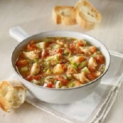 a bowl of soup with bread on the side