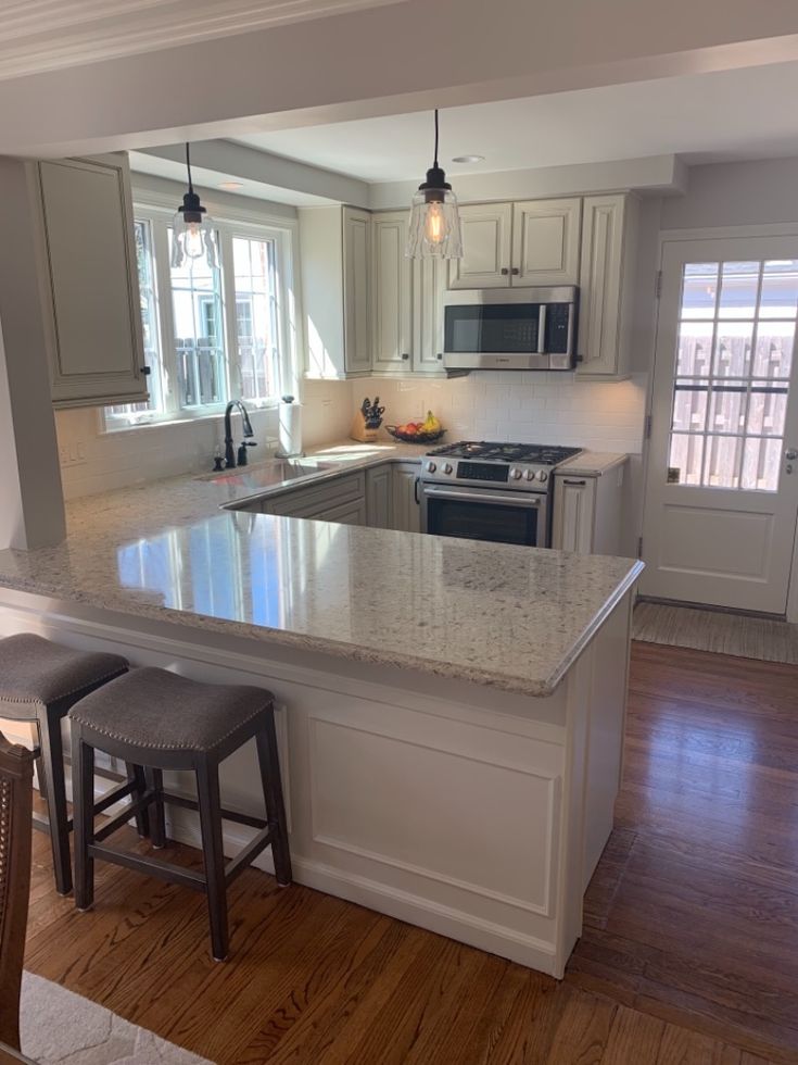 a kitchen with an island and two stools