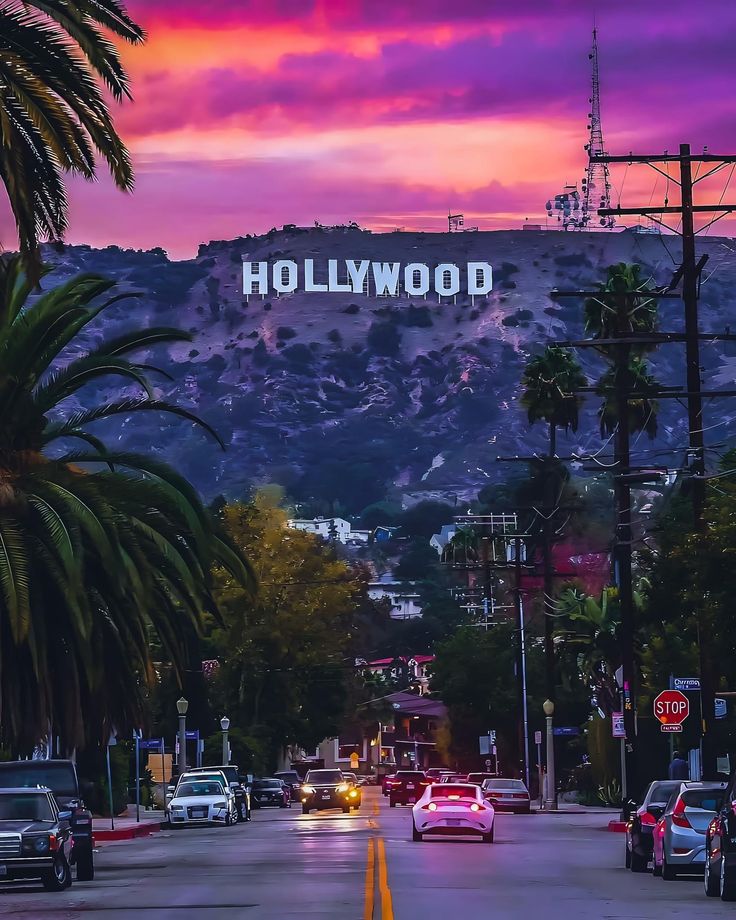 the hollywood sign is lit up at sunset