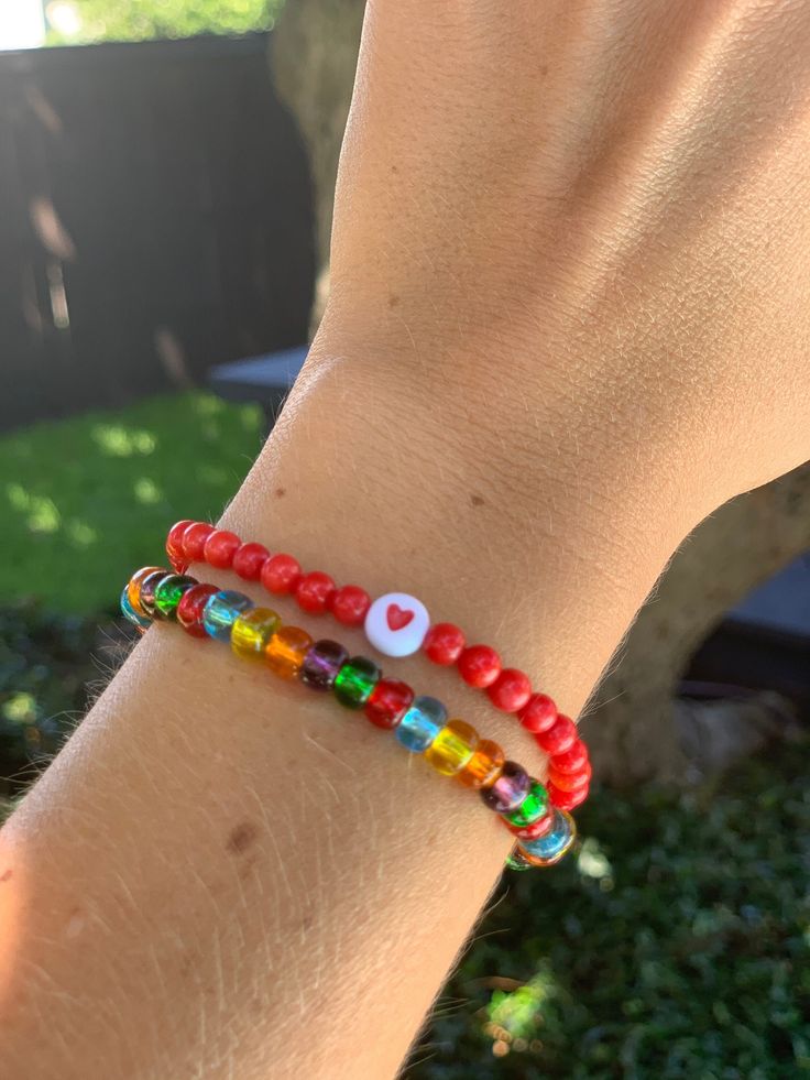 Circular red beads sealed with a heart for lasting luck in love combined with a multi color strand of glass seed beads! - Standard bracelet size is 7 inches. Please message me if you have smaller or larger wrists. Multicolor Letter Beads Bracelets For Valentine's Day, Valentine's Day Multicolor Beaded Bracelets With Letter Beads, Multicolor Letter Beads Bracelet For Valentine's Day, Adjustable Red Friendship Bracelets With Letter Beads, Casual Red Friendship Bracelets With Letter Beads, Red Friendship Bracelets With Colorful Beads For Gift, Gift Heart Bracelet With Colorful Round Beads, Adjustable Red Stretch Bracelet For Everyday, Casual Red Round Beads Friendship Bracelets