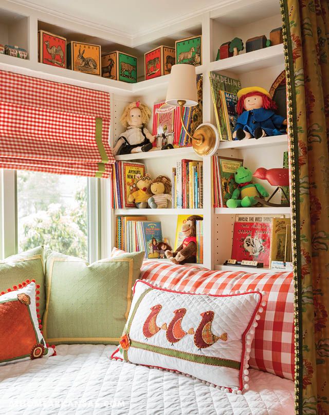 a bedroom with bookshelves filled with children's books and stuffed animals on the shelves