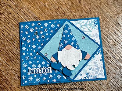 a close up of a greeting card on a wooden table with snowflakes