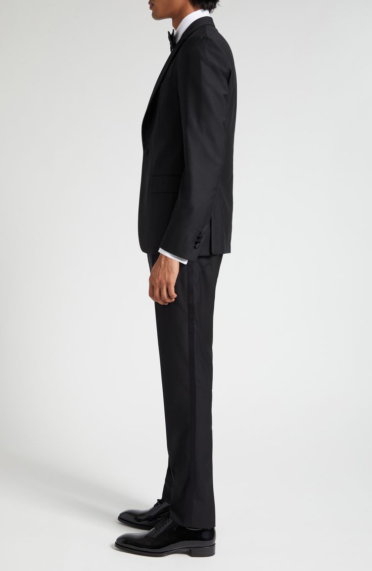 A sumptuous choice for formal wear, this classically styled black tuxedo is impeccably tailored in Italy from stretch-enhanced wool with satin accents. 27" jacket length; 37" inseam; 14 1/2" leg opening; 10 1/4" front rise; 15 1/2" back rise (size 48 EU) Jacket has one-button closure; peaked lapels; chest welt pocket; front flap pockets; side vents Trousers have zip fly with hook-and-bar closure; front slant pockets; back welt pockets Jacket is lined; trousers are lined to the knee 99% virgin wo Black Tuxedo, Pocket Jacket, Fabric Gifts, Free Fabric, Black Fits, Welt Pockets, Formal Wear, Welt Pocket, The Knee