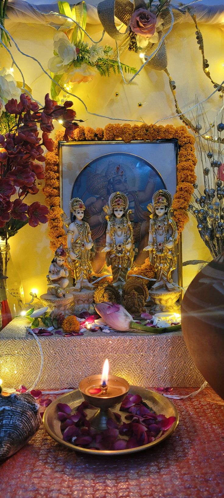 there is a plate with food on it and candles in front of the buddha statue