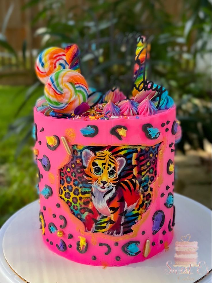 a brightly colored cake decorated with an image of a tiger on it's side