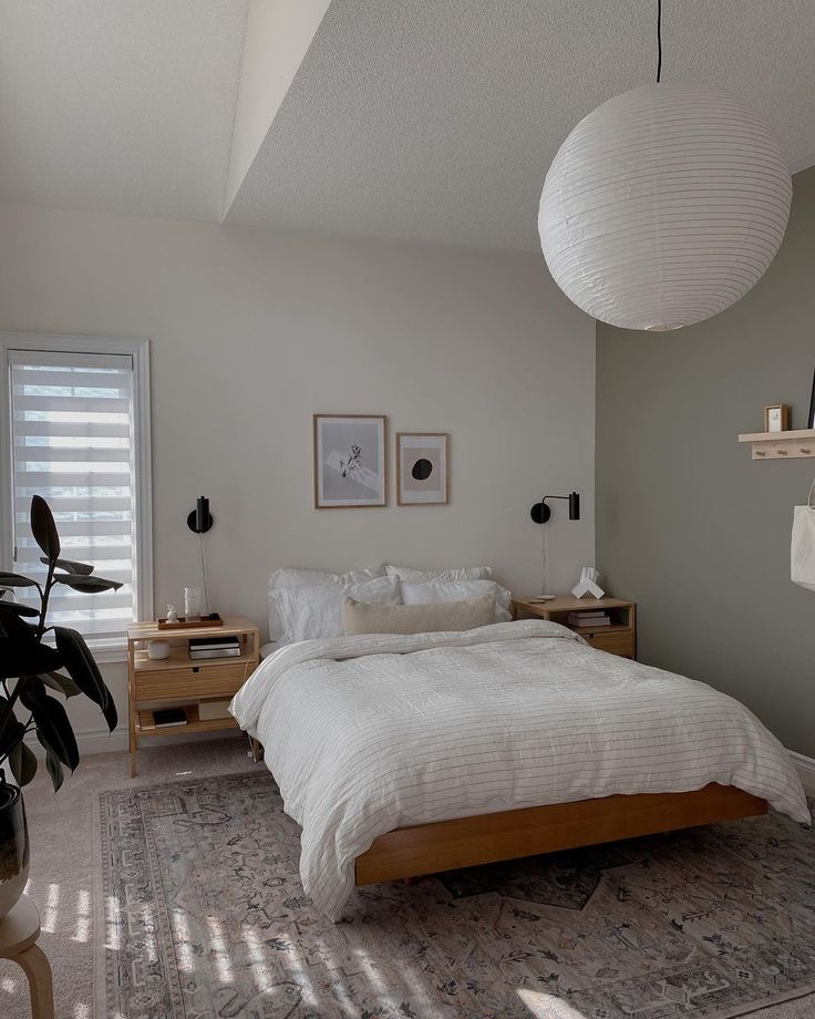 a bedroom with a large bed and two hanging lamps