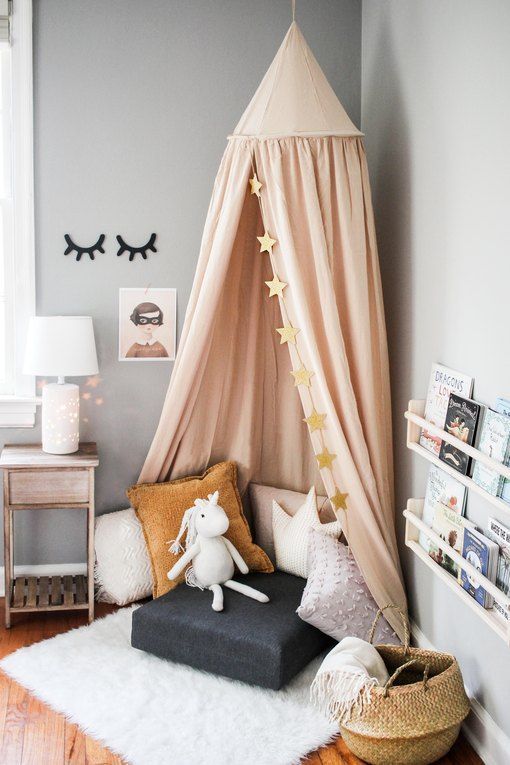 a child's bedroom with a teepee tent in the corner