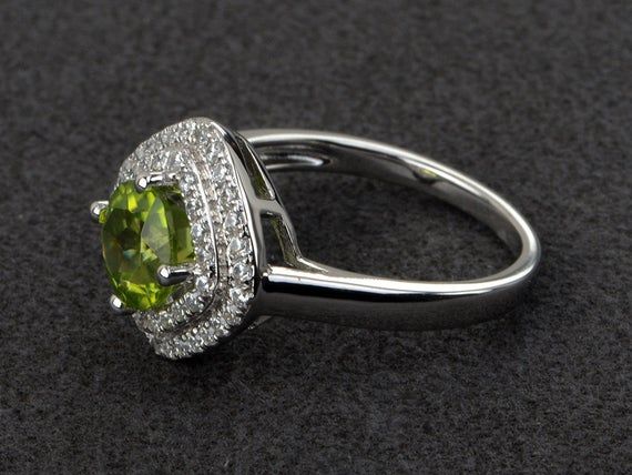 Welcome to my shop, you can find many beautiful gemstone jewelry here, and you also can ask for customized service. Main Stone: natural peridot, round cut 7X7mm, 1.39 carats.Accent Stones: cz Metal: 925 sterling silver plated with rhodium so as to protect the ring from tarnish and keep it shinning. I also can provide metal options such as 14k solid yellow/white/rose goldSetting: prong setting more rings: https://www.etsy.com/shop/XCjewelryStudio?ref=hdr_shop_menuIt's quite comfortable for wearin Green Diamond Ring With Halo Setting, Green Diamond Ring With Halo, Halo Ring With May Birthstone, Fine Jewelry Diamond Ring With Peridot, Emerald Halo Ring For May Birthstone, May Birthstone Halo Ring With Halo Setting, Wedding Jewelry With Peridot In Halo Setting, Green Round Cut Halo Ring, Green Halo Ring With Round Cut