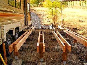 the back end of a camper trailer is being built with wood planks on it