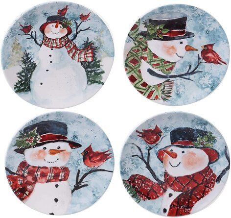 four snowmen with hats and scarfs on plates