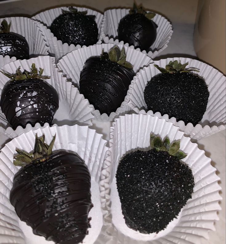 chocolate covered strawberries sitting on top of white paper plates