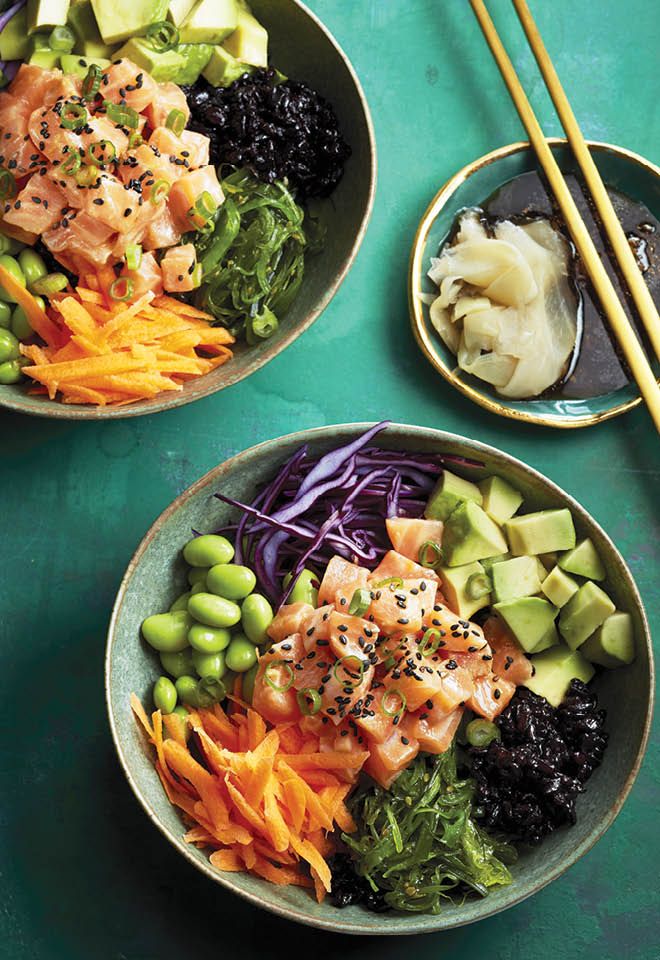 two bowls filled with different types of food and chopsticks next to each other