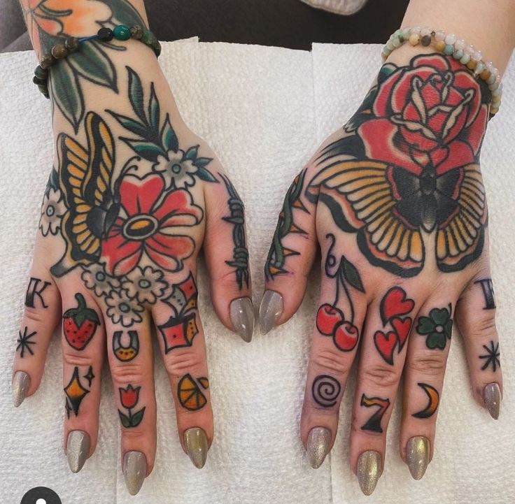 two hands that have tattoos on them and one has flowers on it, while the other is