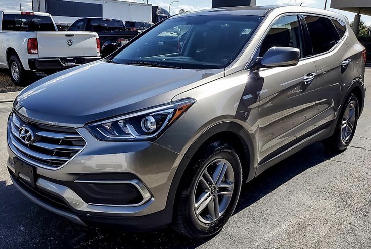 a silver suv parked in a parking lot