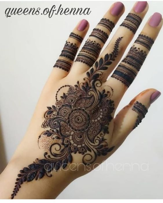 a woman's hand with henna tattoos on it and the words queen of henna written in arabic