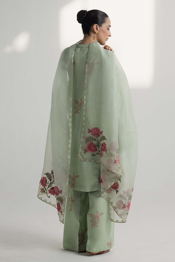 TOP:- Raw SilkBOTTOM:- Raw SilkDUPATTA:- OrganzaOur pastel green silk shirt features floral motifs in block print, embellished with gota work. This handcrafted ensemble is paired with an organza dupatta featuring floral ralli and embroidered accents.Disclaimer: Minor variations in these ensembles are intrinsic to the process of creating handcrafted products and add to their appeal. Green Silk Shirt, Organza Kurti, Zara Shahjahan, Block Printed Suits, Dress Pakistani, Organza Suits, Desi Outfits, Pakistani Style, Desi Wear