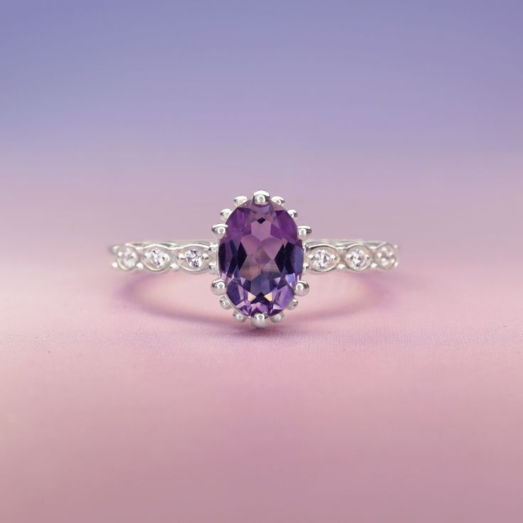 Introducing the exquisite "Juliet" Amethyst and White Topaz Ring – a timeless symbol of love and elegance. Crafted with passion and precision, this enchanting piece will captivate hearts and turn heads wherever it graces your hand. At the center of this ring lies a resplendent amethyst gemstone, deeply alluring with its regal purple hue. The amethyst, known for its association with tranquility and balance, embodies the spirit of royalty, making you feel like a true queen. Its mesmerizing violet Timeless Symbol, Symbol Of Love, Purple Hues, Moon Child, Topaz Gemstone, Topaz Ring, Love Symbols, Amethyst Gemstone, White Topaz