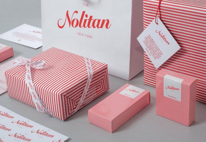 some pink and white boxes with red stripes on them are sitting next to each other