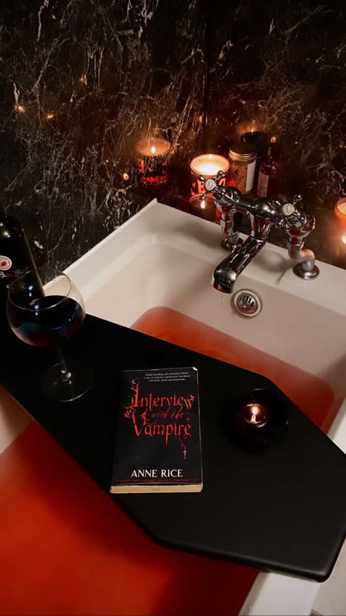 there is a book and some candles in the sink