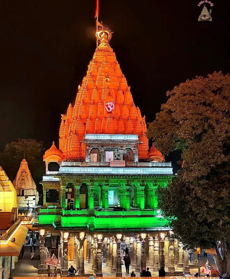 an ornate building lit up in green and orange