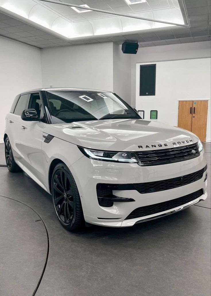 a white range rover parked in a garage