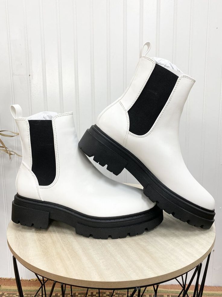 These boots are a chunky pull on boot and are black and white! These are such a cute fashion statement! The material is easy to wipe off and fun to wear everywhere! Trendy Chunky Winter Moto Boots, Chunky Winter Moto Boots, Trendy High-top White Martin Boots, Trendy Chunky Ankle Moto Boots, Trendy White High-top Martin Boots, Trendy White Martin Boots With Round Toe, Trendy Chunky Platform Ankle Boots, Trendy Chunky Ankle Boots, Trendy Martin Boots With Lug Sole