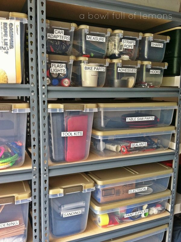 the shelves are filled with plastic containers and bins for various types of things to put in them