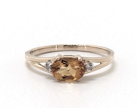 an engagement ring with a brown stone and two diamonds