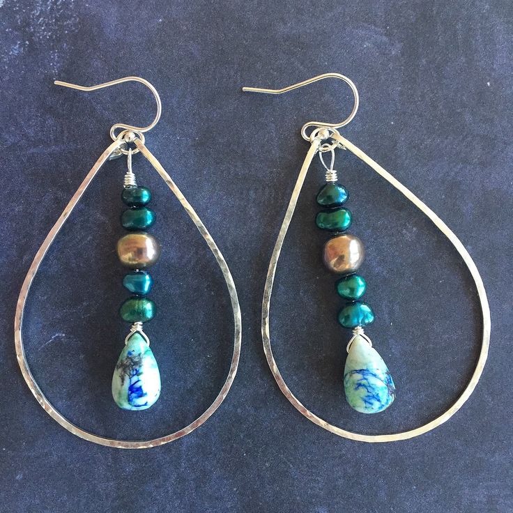 Please note all stones are unique. This is a photo of the first pair made. Arizona oyster lapis turquoise look like delightful landscapes. I have combined these unique teardrops with peacock and multicolored freshwater pearls on sterling silver. I have used my KRISTIANA hammered hoops in the medium size in sterling silver to create these hoops. The approximate length is 2.5". Please choose your earwire preference. Unique Handmade Turquoise Beaded Earrings, Green Teardrop Jewelry With Pearl Drop, Bohemian Sterling Silver Jewelry With Pearl Drop, Green Teardrop Pearl Drop Jewelry, Silver Teardrop Earrings With Natural Stones, Teardrop Czech Glass Wire Wrapped Jewelry, Bohemian Sterling Silver Pearl Drop Jewelry, Blue Teardrop Pearl Drop Jewelry, Turquoise Teardrop Jewelry With Polished Beads