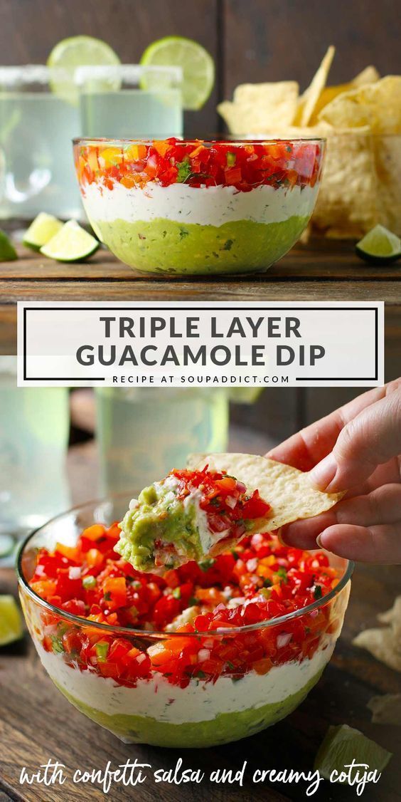 a person dipping guacamole into a bowl with tortilla chips on the side