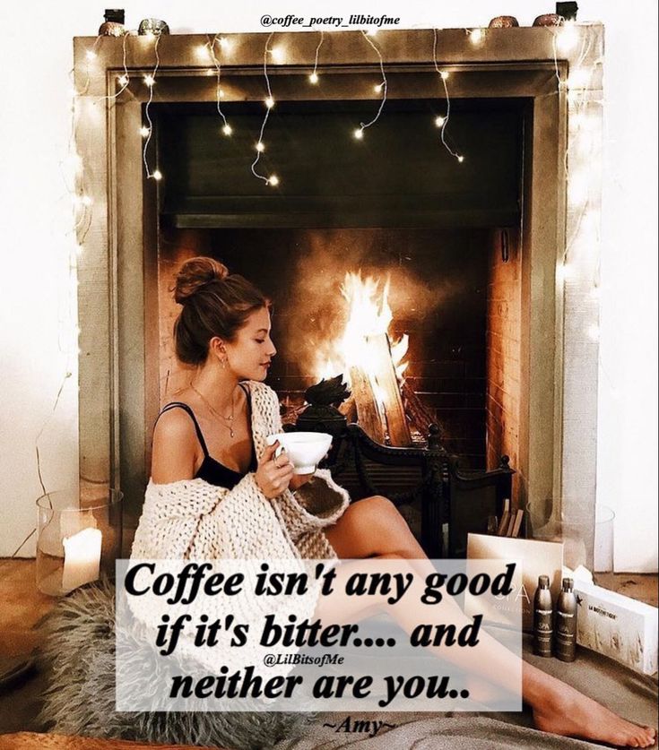 a woman sitting in front of a fireplace with a cup of coffee and a quote on it