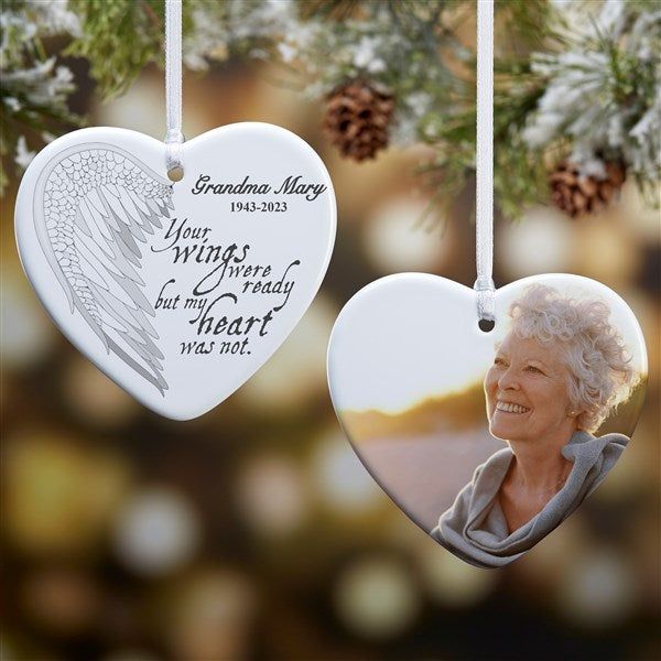 two heart shaped ornaments hanging from a christmas tree with the words grandma mary, your wings will be ready for that