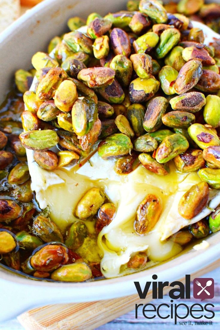 a white bowl filled with brussel sprouts and cheese covered in sauce