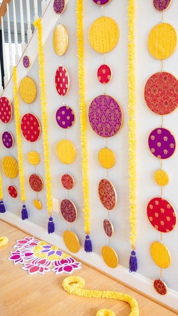 the wall is decorated with colorful paper circles and tassels, along with other decorations