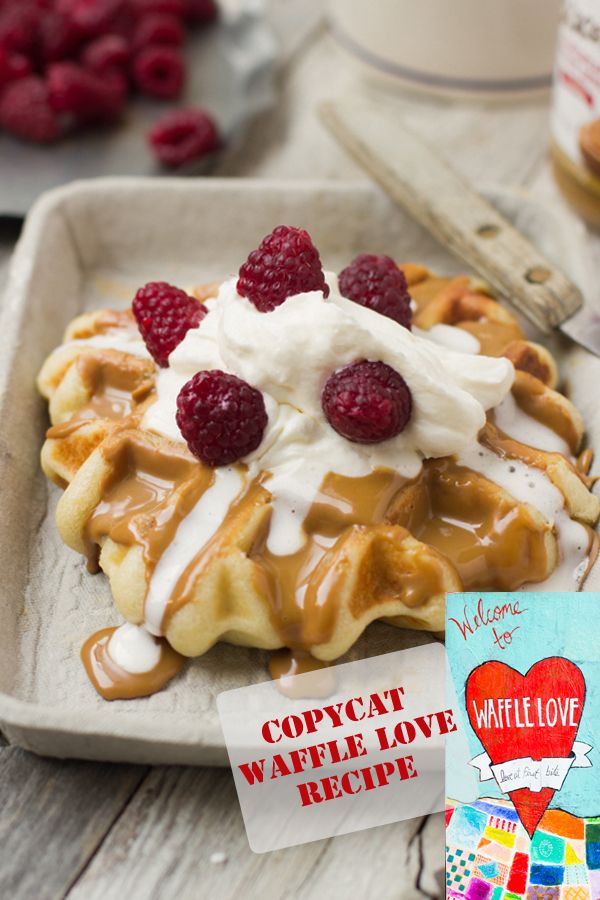 a waffle topped with whipped cream and raspberries