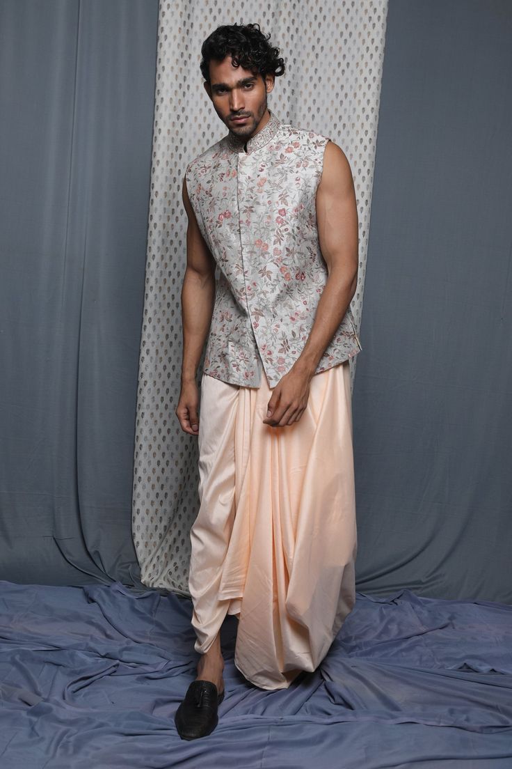 Grey bundi with embroidered floral motifs.
Component: 1
Pattern: Embroidered
Type Of Work: Floral
Neckline: Band
Sleeve Type: Sleeveless
Fabric: Cotton Viscose
Color: Grey
Other Details: 
Note: Dhoti worn by the model is not for sale
Occasion: Wedding - Aza Fashions Nehru Jackets, Cotton Viscose, Grey Floral, Floral Motifs, Floral Botanical, Not For Sale, Grey Cotton, Aza Fashion, Floral Motif