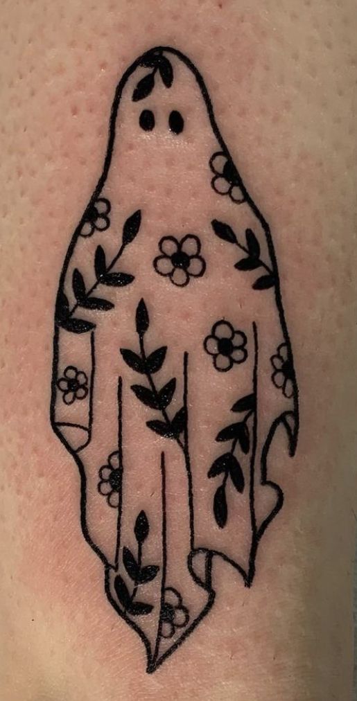 a tattoo on the back of a person's arm with flowers and leaves in it