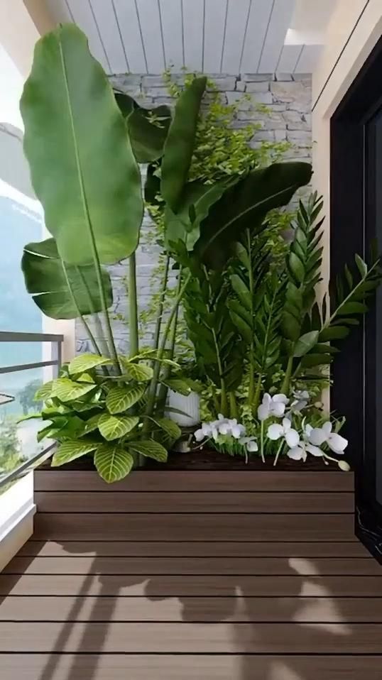 a planter filled with lots of green plants on top of a wooden floor