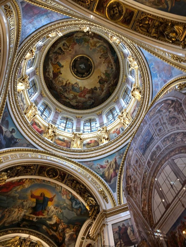 an ornate ceiling in a church with paintings on it