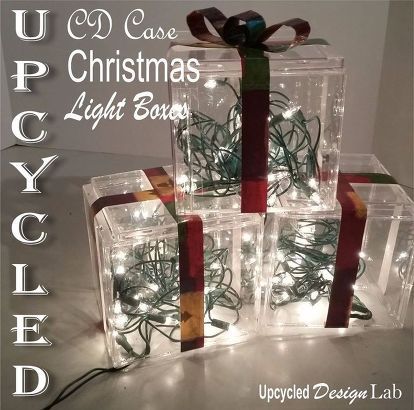 christmas lights are wrapped in clear plastic boxes and tied with red ribbon on the bottom