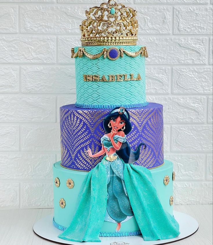 there is a three tiered cake with princess ariel on top and the word disney written on it