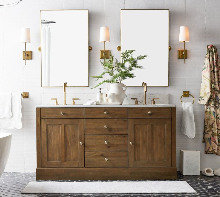 a bathroom with two sinks and mirrors on the wall